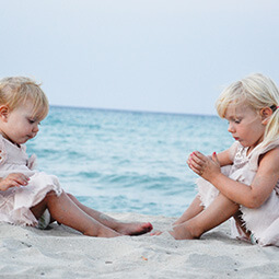 sisters beach holiday fun travelling sand playing blonde baby cute real UG travel content photography